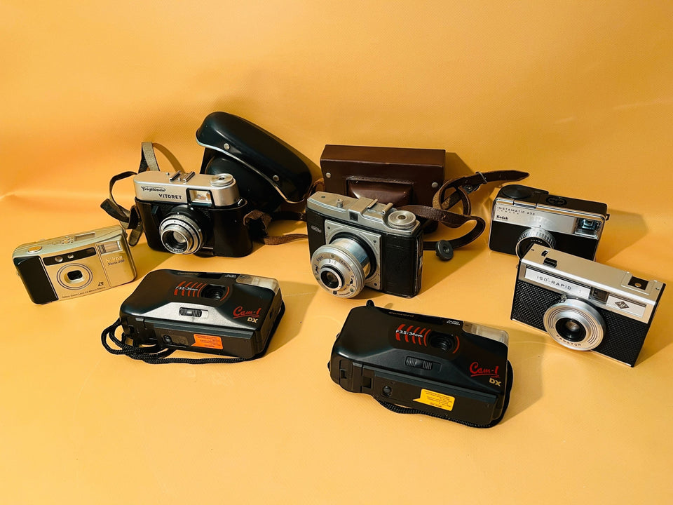 Collection of 7 vintage cameras displayed together