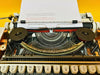 Olympia Traveller Deluxe typing sample QWERTY typeface orange typewriter