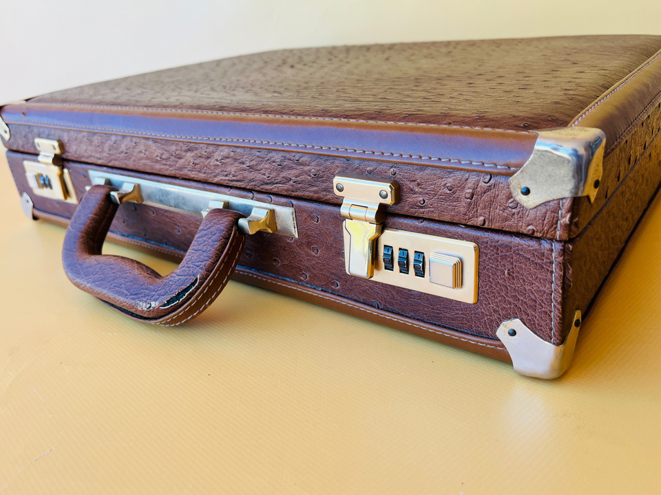 Close-up shot of the authentic ostrich quill follicles and natural grain of the vintage leather suitcase
