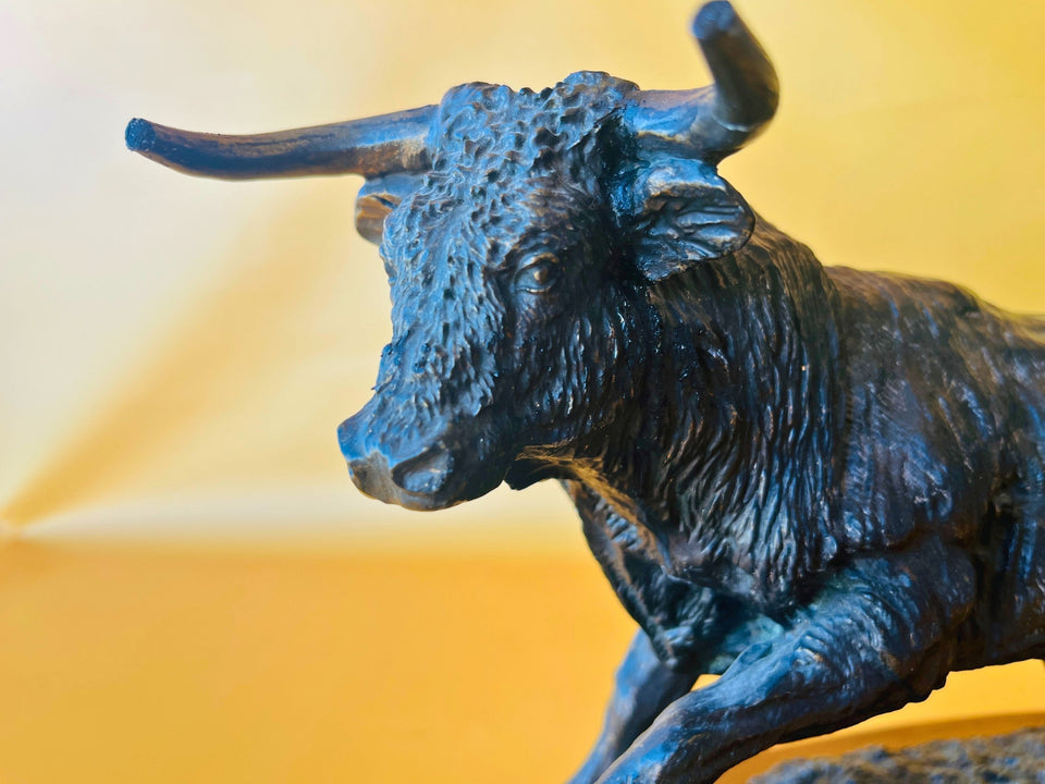 Close-up view of the bull's head and horns, highlighting the detailed texture and handcrafted appearance of the resin sculpture.