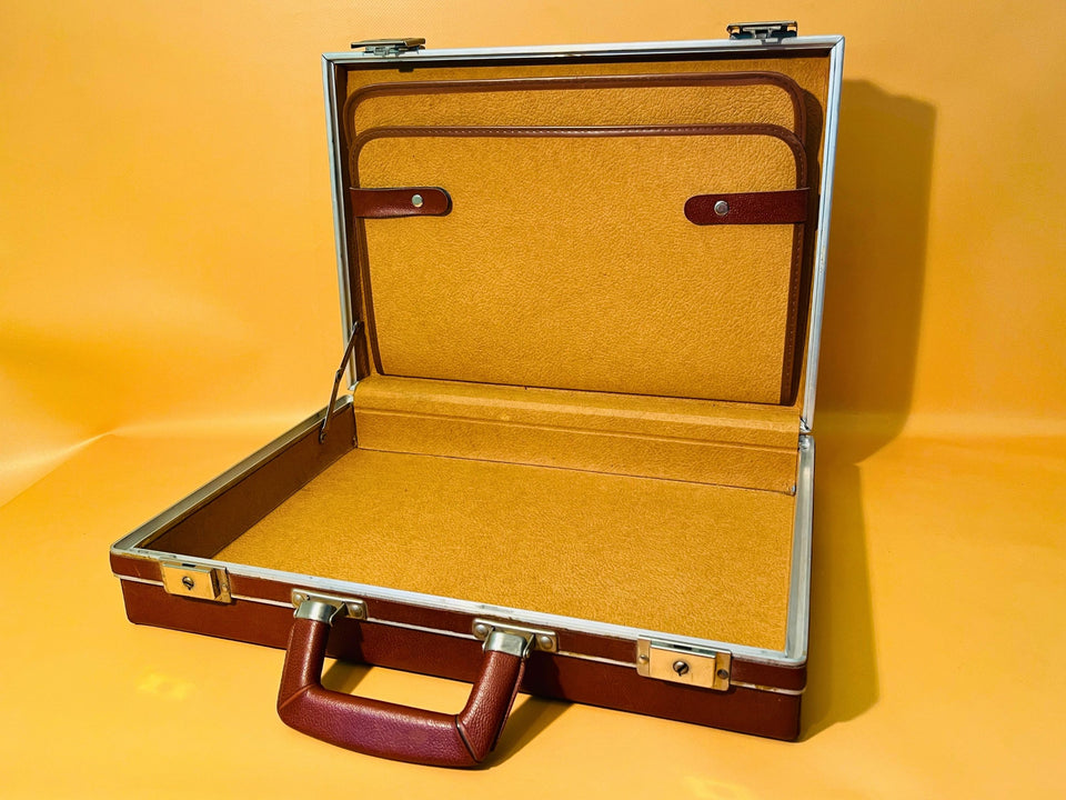 Vintage hard case open showing mustard-gold interior lining