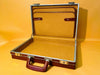 Vintage hard case open showing mustard-gold interior lining
