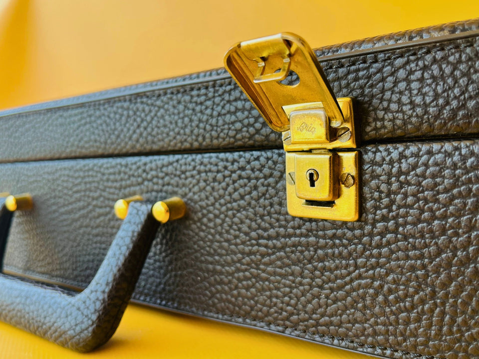 Vintage briefcase gold latch Briq detail close up