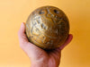 Brass celestial globe zodiac engraving close up