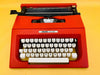 Detailed shot of the Spanish QWERTY keyboard on a red Olivetti College showing the Ñ key and original black keycaps.