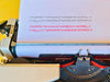 Detailed view of the Spanish QWERTY keyboard on a professionally revised Brother 1350, showing the Ñ key and crisp white lettering.