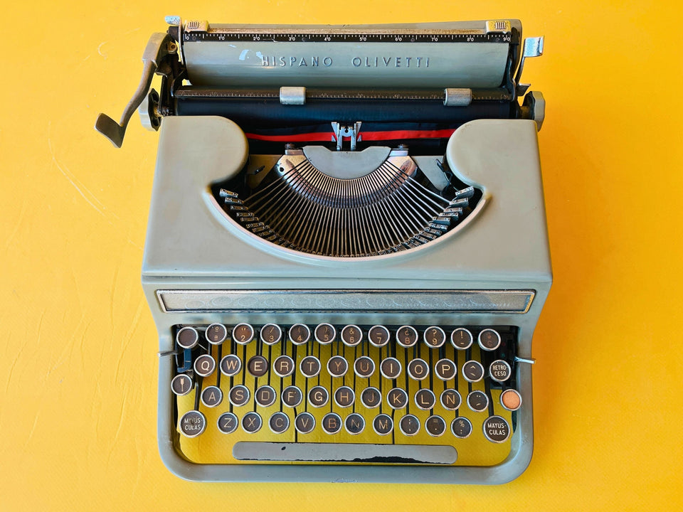 Detailed shot of the metal-rimmed glass keys on a Hispano Olivetti Studio 46 featuring the Spanish QWERTY layout and Ñ key