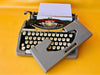Brother Typewriter (1970s) – Gray Portable Manual Typewriter with Leather Case