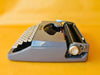Brother Typewriter (1970s) – Gray Portable Manual Typewriter with Leather Case