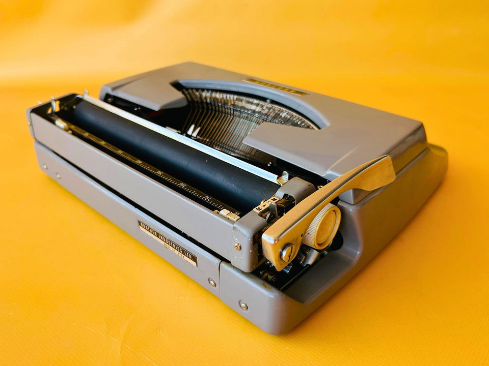 Brother Typewriter (1970s) – Gray Portable Manual Typewriter with Leather Case