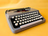 Brother Typewriter (1970s) – Gray Portable Manual Typewriter with Leather Case