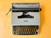 Olivetti Pluma 22 keyboard detail QWERTY keys close-up gray typewriter