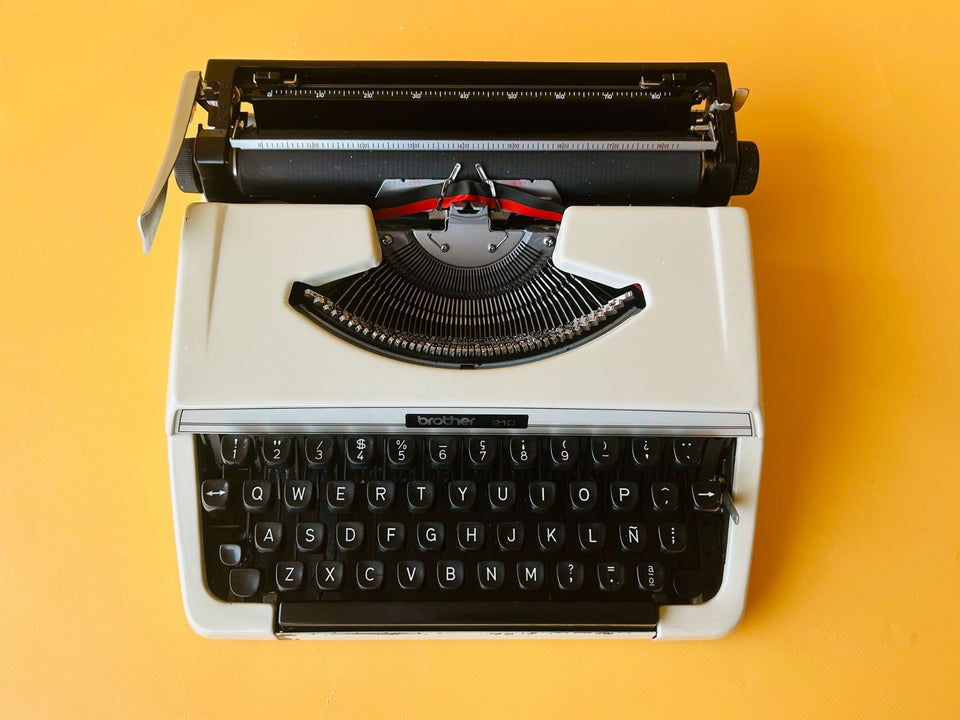 Detailed shot of the Spanish QWERTY keyboard on a Brother 210 showing the Ñ key and original 1970s branding.