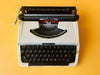 Detailed shot of the Spanish QWERTY keyboard on a Brother 210 showing the Ñ key and original 1970s branding.