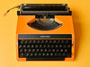 Detailed shot of the Spanish QWERTY keyboard on an orange Silver Reed featuring the Ñ key and crisp black keycaps