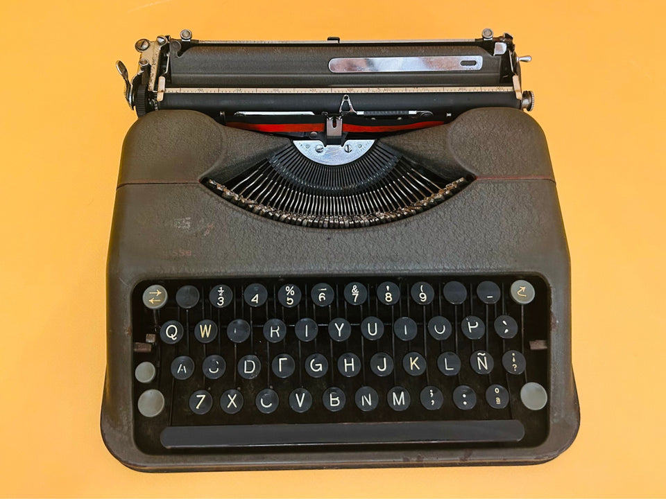 Detailed shot of the circular mint-green keys on a Swiss-made Hermes Baby featuring the Spanish QWERTY layout and Ñ key