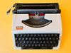 Detailed shot of the Spanish QWERTY keyboard on a Brother 210 showing the pristine black keycaps and the 'A' key mechanism.