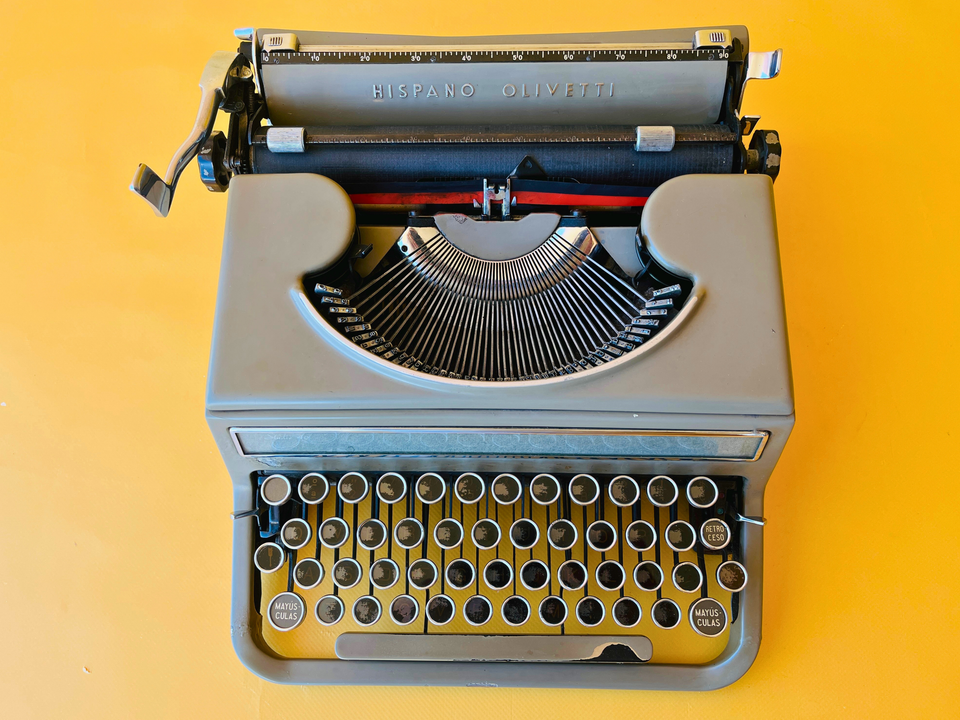 Close-up shot of the unique black-faded keys on a Hispano Olivetti Studio 46, showing visible letters and Spanish QWERTY layout.
