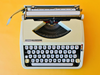 Detailed shot of the Spanish QWERTY keyboard on a 1967 Hermes Baby showing the signature mint-green keys and perfect alignment