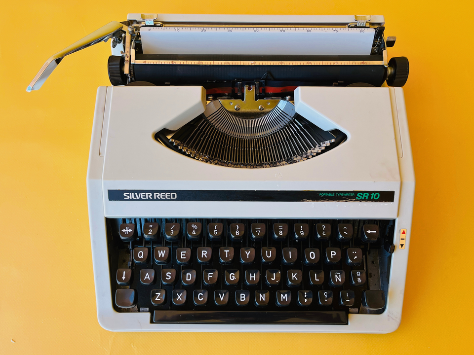 Detailed shot of the Spanish QWERTY keyboard on a Silver Reed SR 10 showing the Ñ key and professional black keycaps