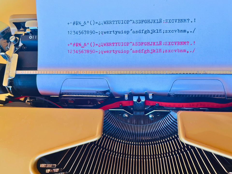 Detailed view of the original vintage hardshell carrying case and accompanying integrated keyholder accessory included with the Kovac typewriter.