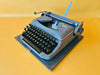 Erika Model 100 portable typewriter with Spanish QWERTY keyboard and original carrying case