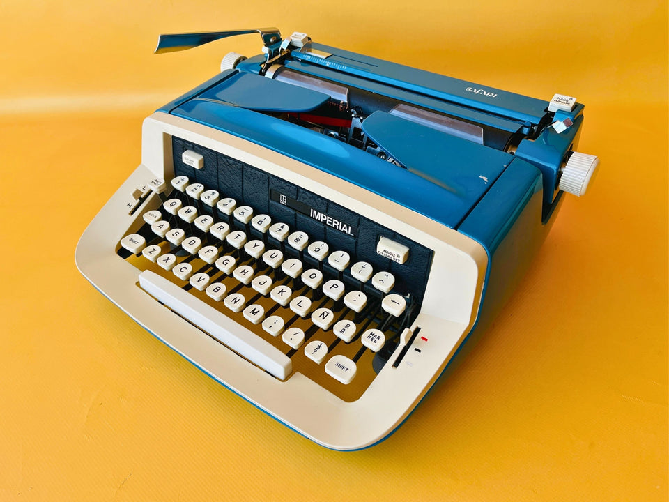Imperial Safari blue and white portable typewriter with Spanish QWERTY keyboard