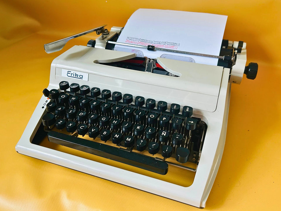 Erika Mod 100 white portable typewriter with Spanish QWERTY keyboard and original carrying case
