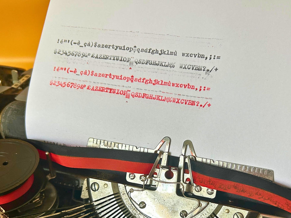 Writing sample produced by Brother Deluxe manual typewriter demonstrating print quality and alignment in black and red ink