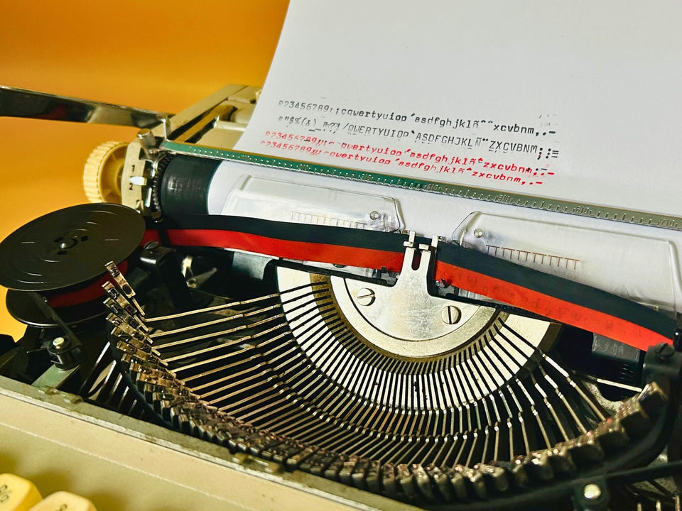 Vintage Maritsa 22 portable typewriter in burgundy red finish with Spanish keyboard layout