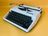 Adler Tippa white portable typewriter with English QWERTY keyboard and original case