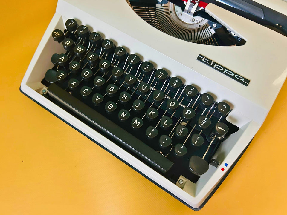 Adler Tippa portable typewriter close-up showing English QWERTY keyboard
