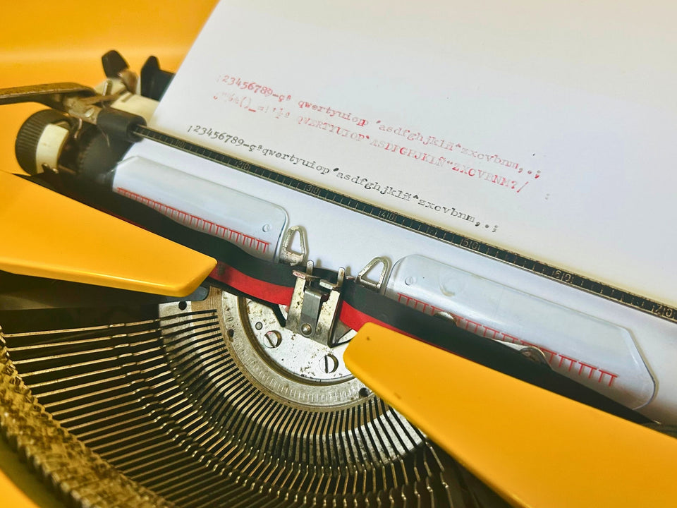 Adler Tippa S Spanish keyboard typewriter with Ñ key in bright yellow finish