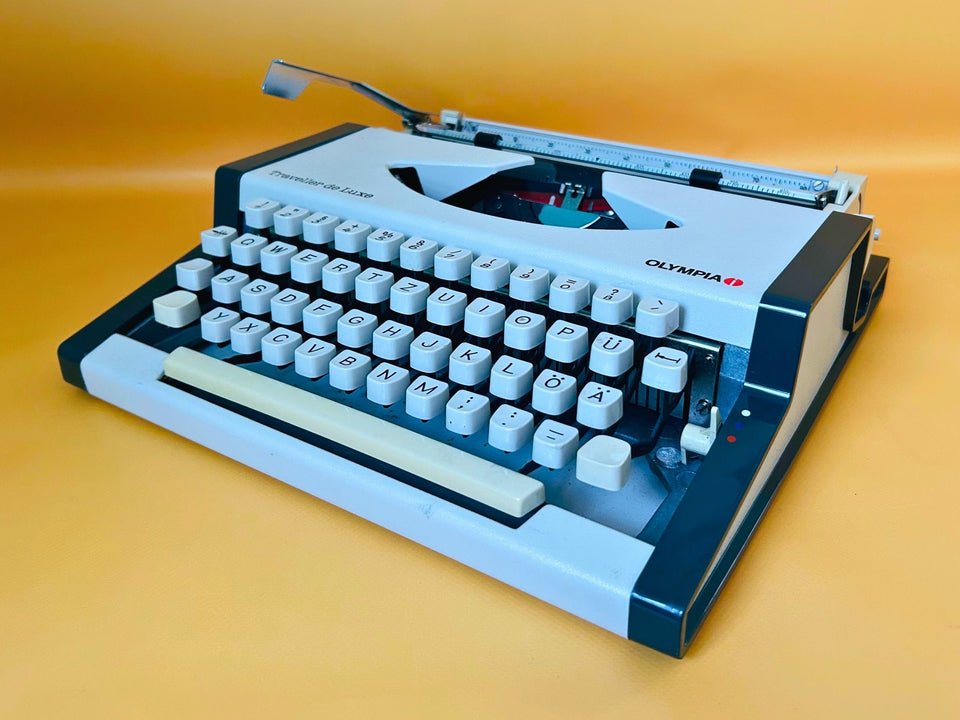 Olympia Traveller de Luxe vintage portable typewriter in original white and dark grey finish with German QWERTZ keyboard