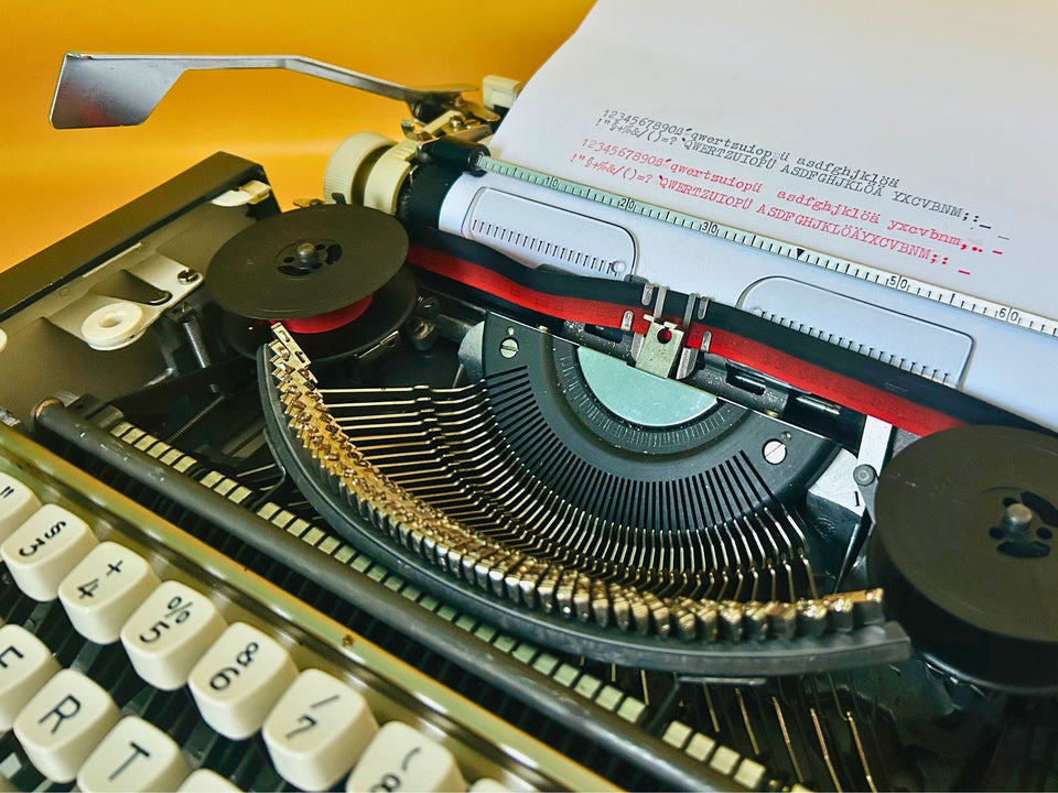 Close-up of the German QWERTZ keyboard on an Olympia Traveller de Luxe vintage typewriter showing original keys and excellent condition