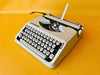 Hermes baby typewriter on yellow background