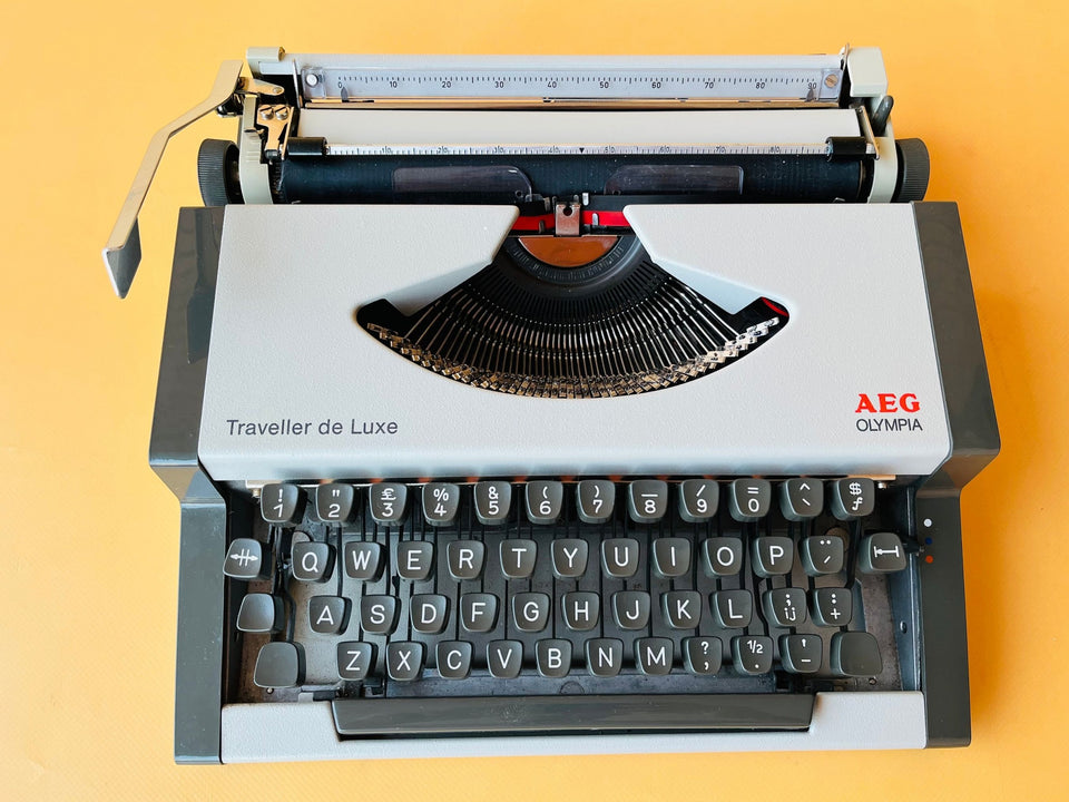Working typewriter AEG Olympia Traveller de Luxe white top view showing type basket and ribbon