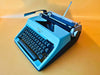 Working typewriter Olympia Monica custom cyan lid, main view with case