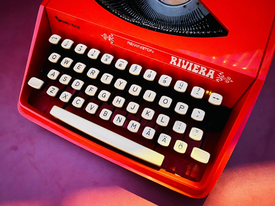 Angled view of an orange Remington Riviera typewriter with cream keys
