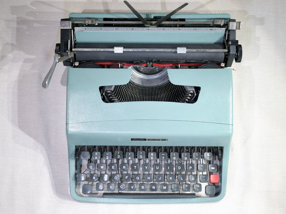 Detailed shot of the Spanish QWERTY keyboard on an Olivetti Lettera 32 featuring the Ñ key and the iconic red tabulator button.