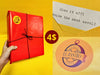 Red gift wrap tied with black twine and El Rastro Antiques seal