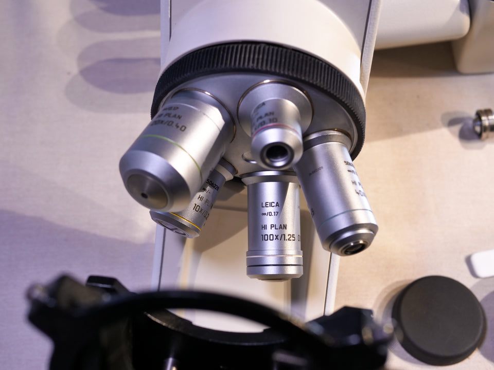 Leica DM1000 microscope objective lenses close-up clinical lab equipment detail