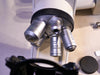 Leica DM1000 microscope objective lenses close-up clinical lab equipment detail